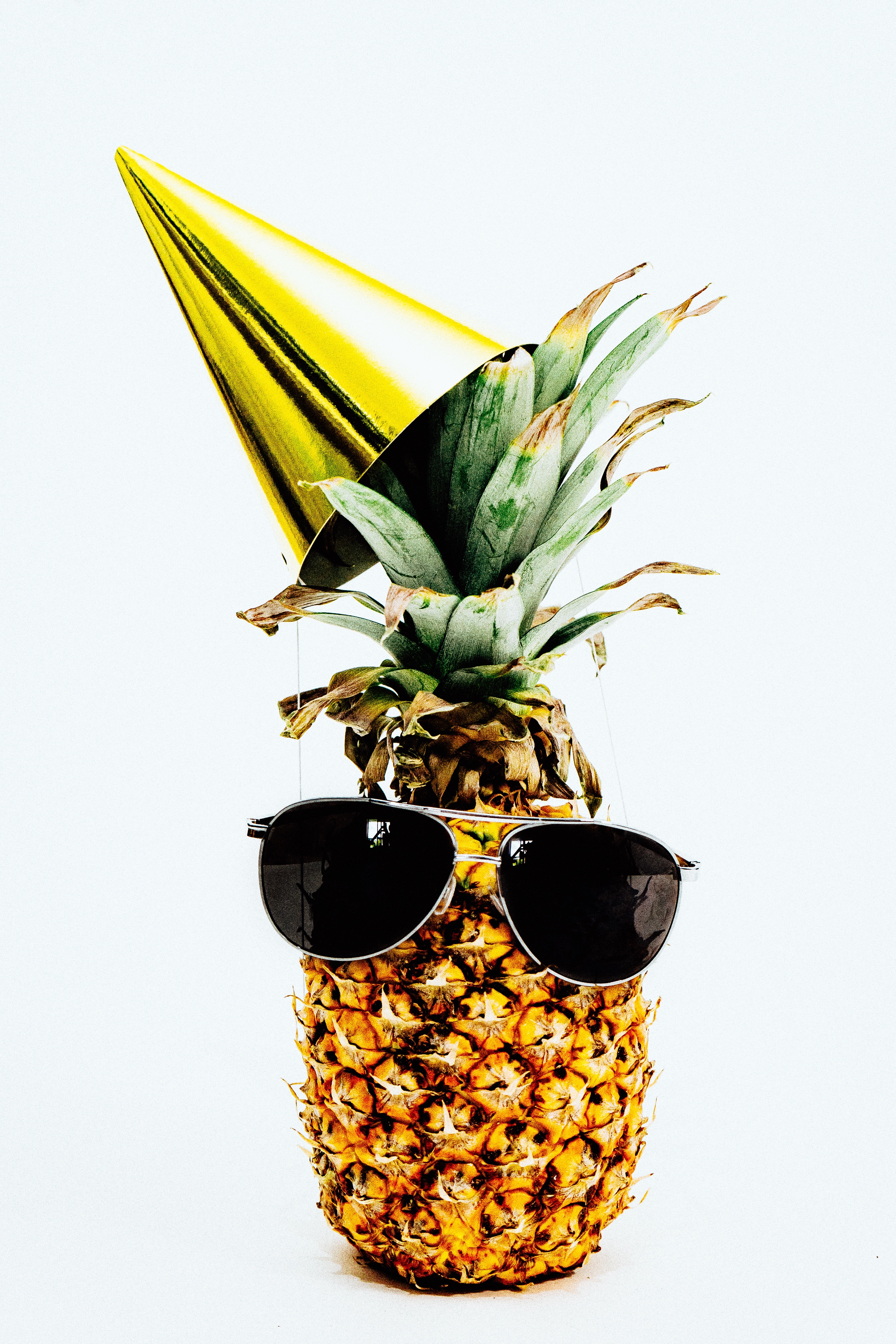 pineapple wearing sunglasses and party hat